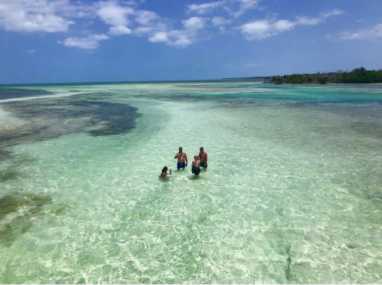 Family playing on a sandbar
