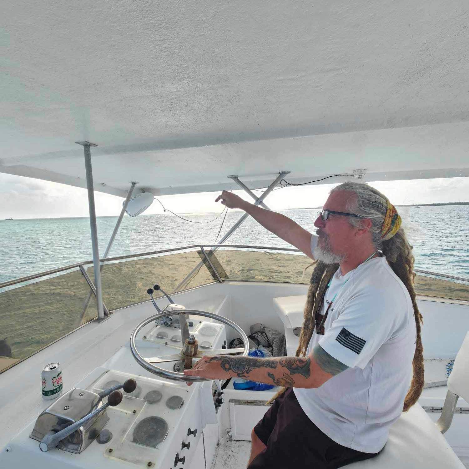 Captain Warren Clary at the helm on a Lower Keys sandbar