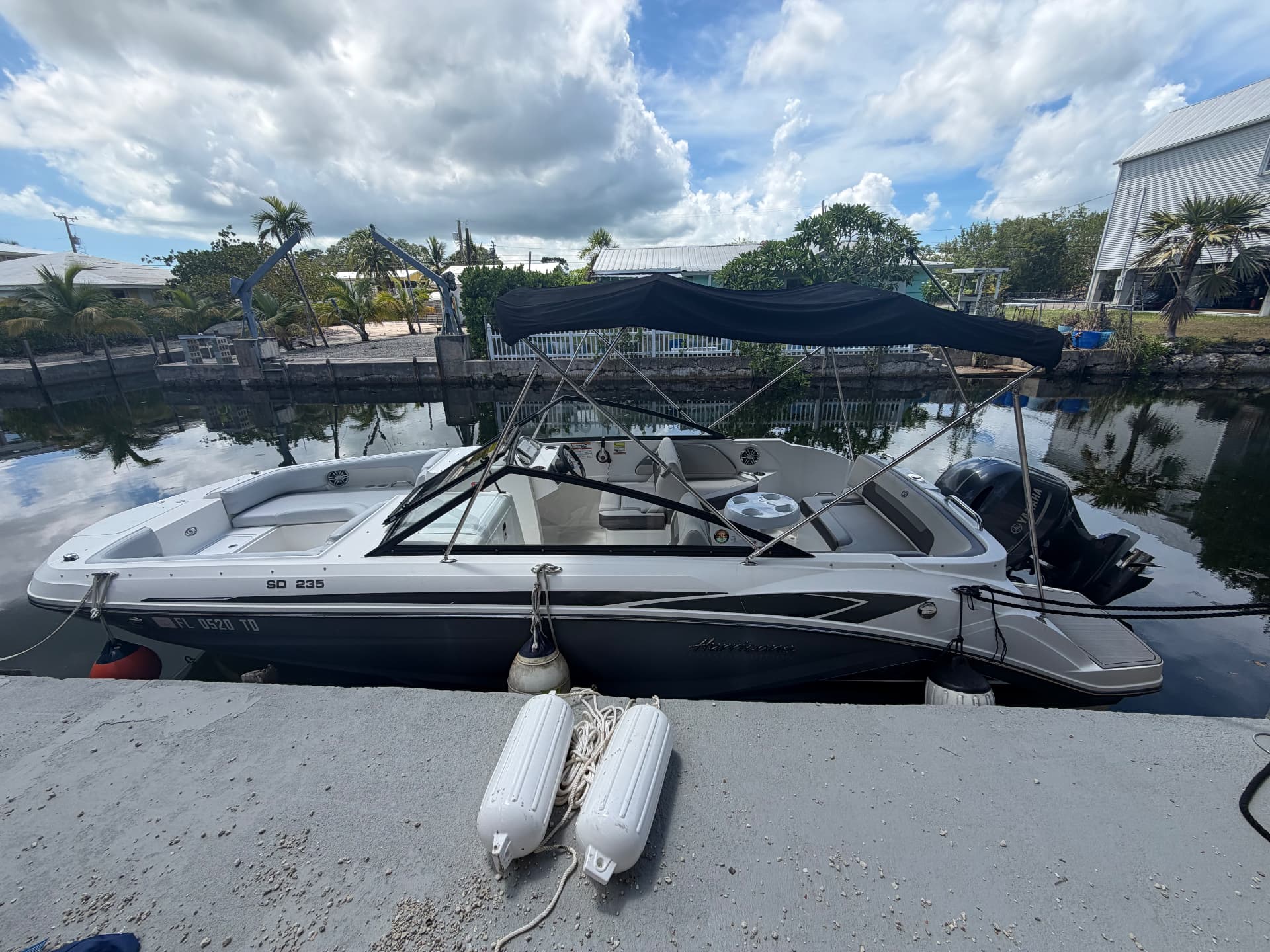 Mangrove Monkey Charters' Hurricane SD 235 deck boat docked in a Big Pine Key canal