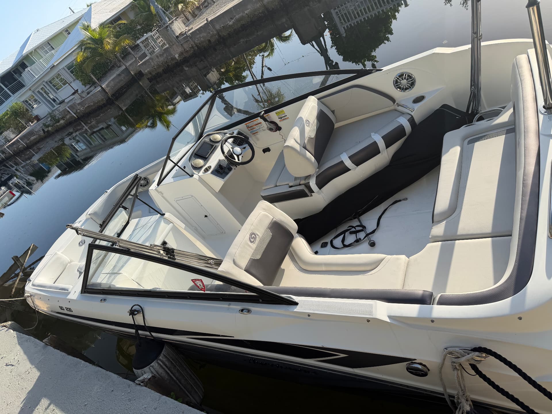 Helm and cockpit of the deck boat with steering wheel and captain's seat